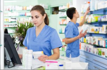 Attentive pharmacy Technicians reviewing meds